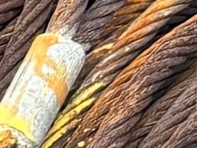 Close-up of a used wire rope coil with a socket fitting