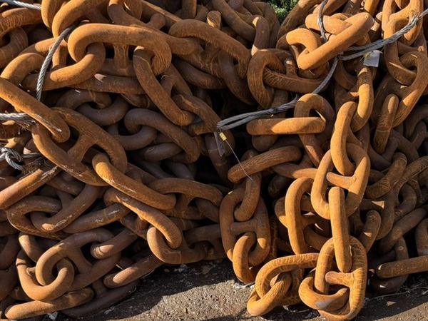Piles of used stud link chain in our depot